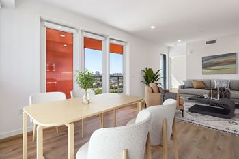 A modern dining room with a table and chairs.